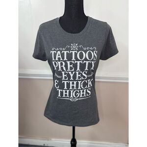 Tattoos, Pretty Eyes, and Thick Thighs Short Sleeve Graphic Tee Size Medium